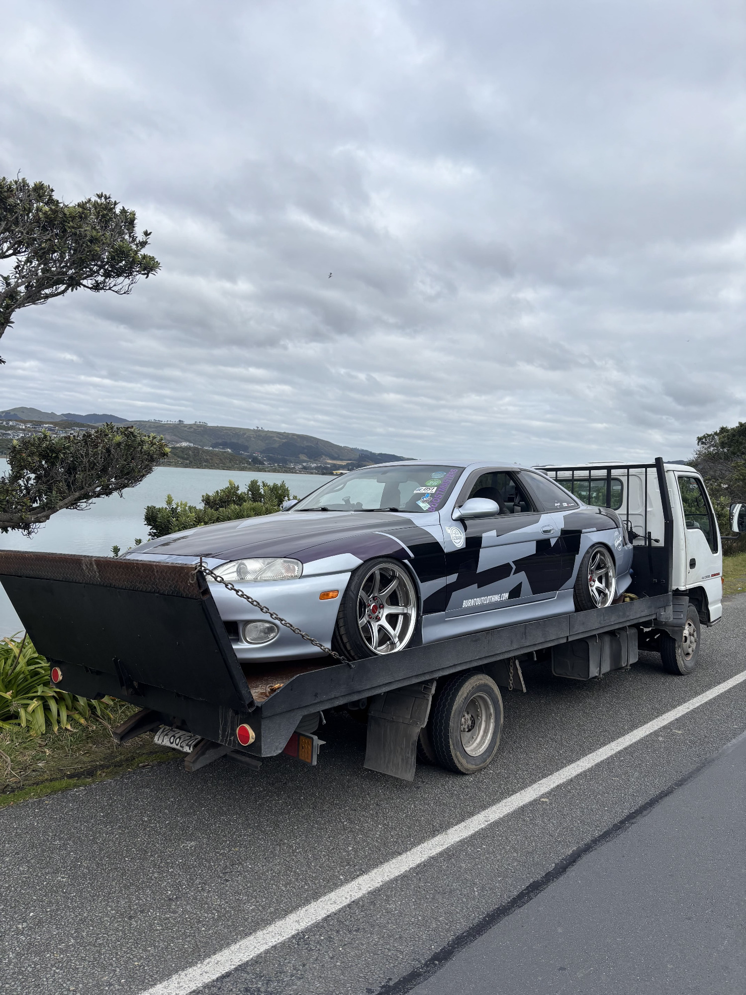 Car on a Mack's Garage flatbed truck